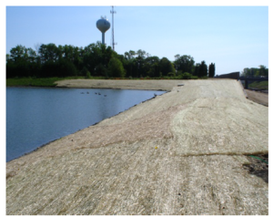 This photo shows Erosion control blanket stabilizes pond slopes.PNG