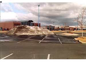 Photo showing Snow plowed and piled in parking lot