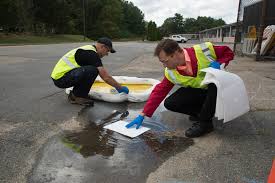 Staff cleaning after a spill at a municipal operations facility