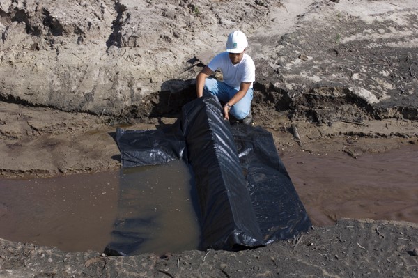This picture shows an installation of triangular silt dike in channel