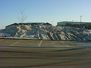 Photo showing Plowed snow off parking lot to grass area