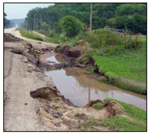 This photo shows A road near Elba Minnesota, was damaged by flashfloods in August 2007