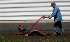 This image shows rototilling compost into the soil.