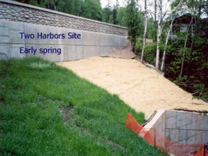 Photo of Two Harbors site in early spring. Compost blanket on left, seeded straw mat on right