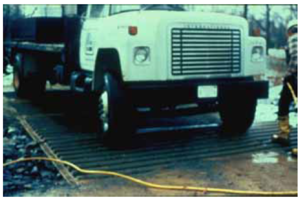 This photo shows A vehicle wash rack may be needed to remove sediment from tires