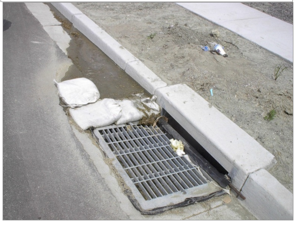 This picture shows Inlet protection for curb inlet using gravel bags and filter suspended in the inlet